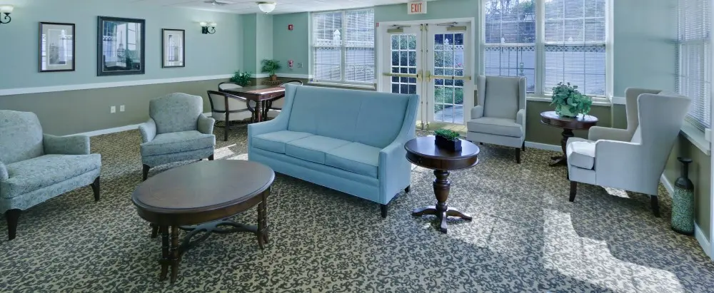 Common sitting area with light blue furniture in an assisted living facility in West Knoxville, TN